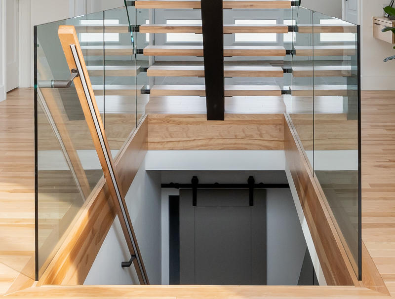 Wood rails with a mix of slotted glass and glass affixed by standoffs.