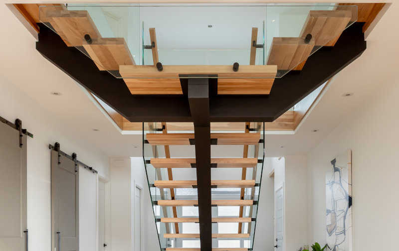 Wood rails with glass affixed by standoffs.