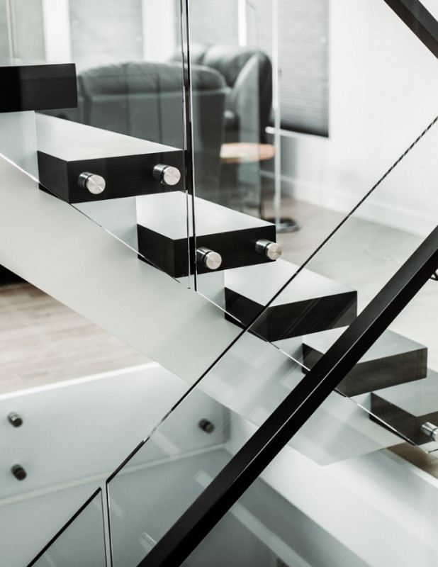 Black metal rails with glass affixed by standoffs.