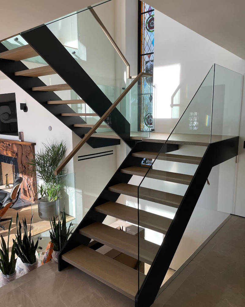 San Diego stairs showing a double end stringer design with a slotted glass and wood guardrail.