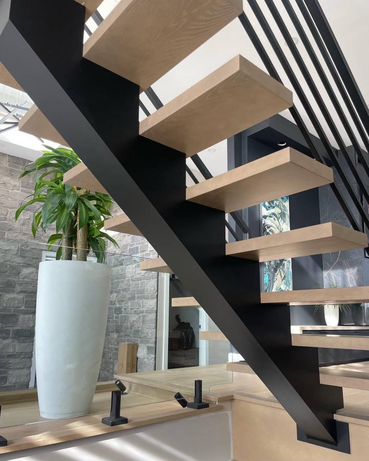 Seattle stairs showing seamless steps from the underside wwith metal and glass balusters.